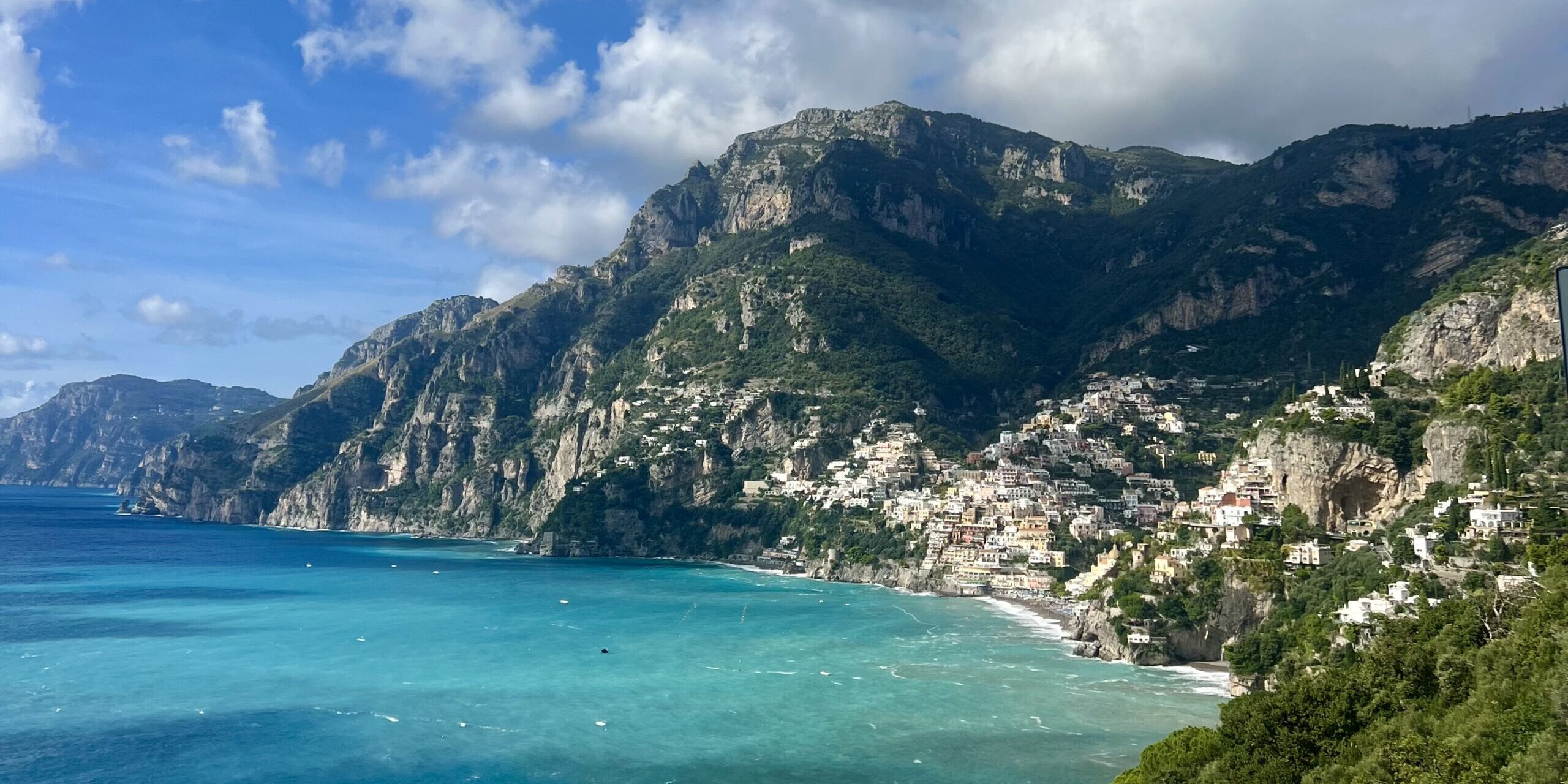 The view of Positano from afar with turquoise blue waters